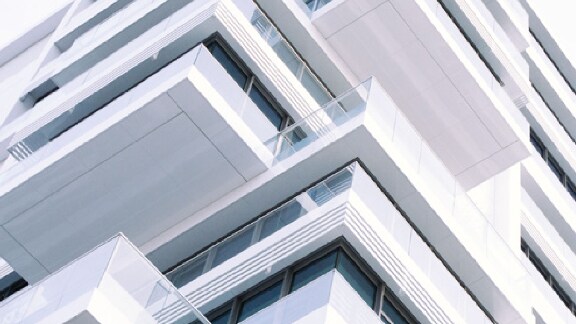 Upwards view of a building with balconies on each floor
