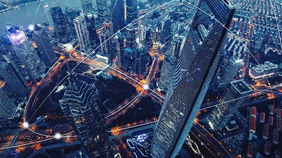 Ariel-view of a city skyline at dusk with graphics depicting interconnectivity