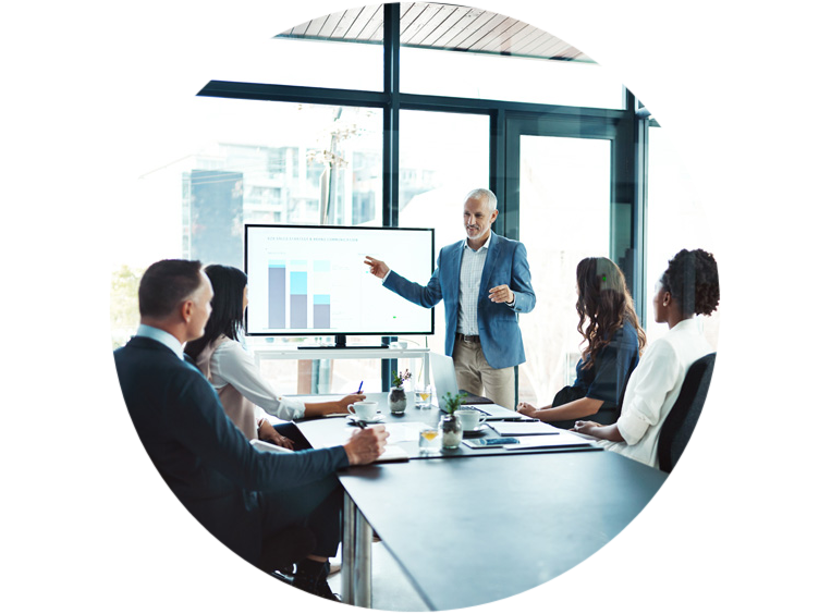 Man giving a presentation in a conference room with four people sitting at a table